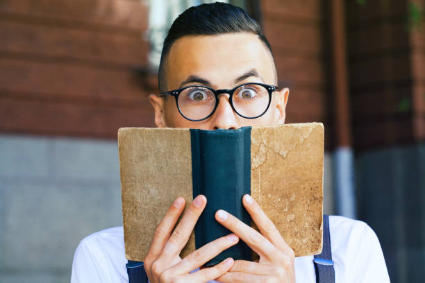 Young man reading a book stock photo