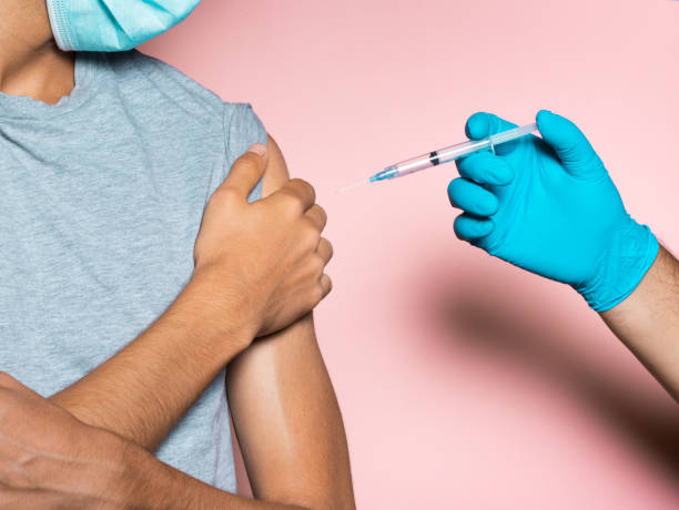 Young man refusing vaccine, anti vaccination concept stock photo