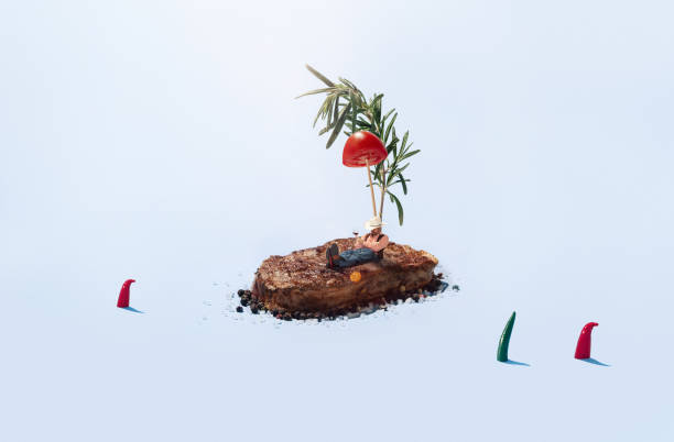 Young man resting on a steak-island under the rosemary palm with cherry tomato Young man resting on a steak-island under the rosemary palm with cherry tomato, surrounded by ocean with pepper like sharks. Tasty food, restaurant, crafted cuisine lover. Fantasy, dreams, inspiration. spices of the world stock pictures, royalty-free photos & images