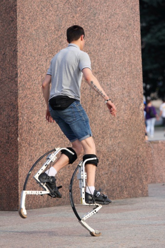Young Man Running On A Jumping Stilts Stock Photo - Download Image Now -  iStock