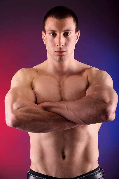 Handsome power athletic man bodybuilder demonstrates his 