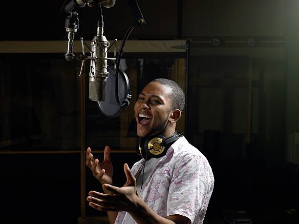 Young man singing  recording studio stock pictures, royalty-free photos & images