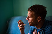 istock Young man treating asthma with inhaler 1350082301