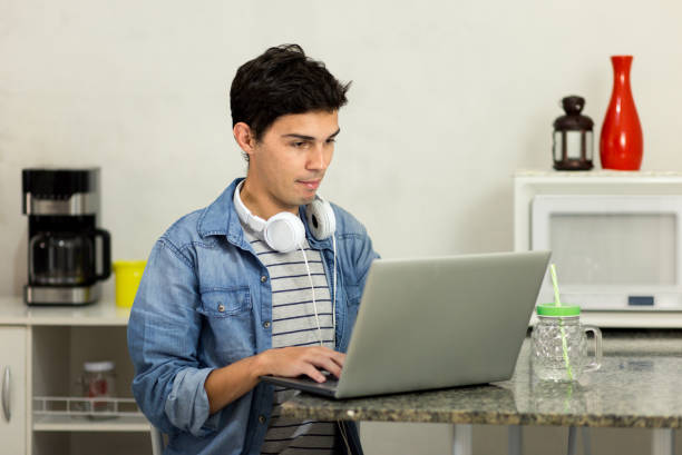 Young man using his laptop stock photo