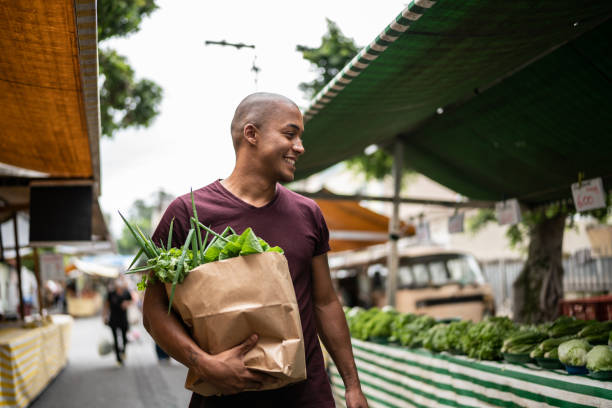 Young man walking in a street market stock photo