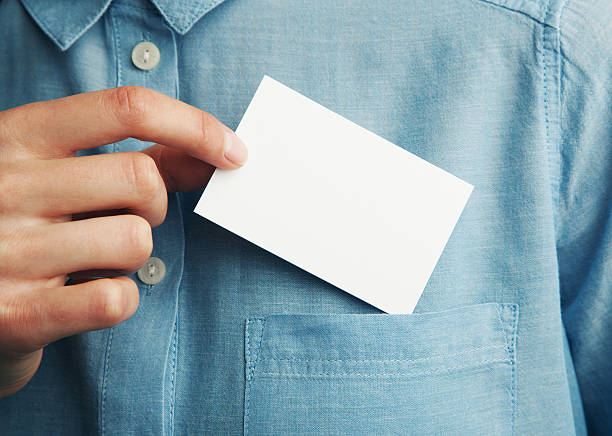 Young man who takes out blank business card from the stock photo