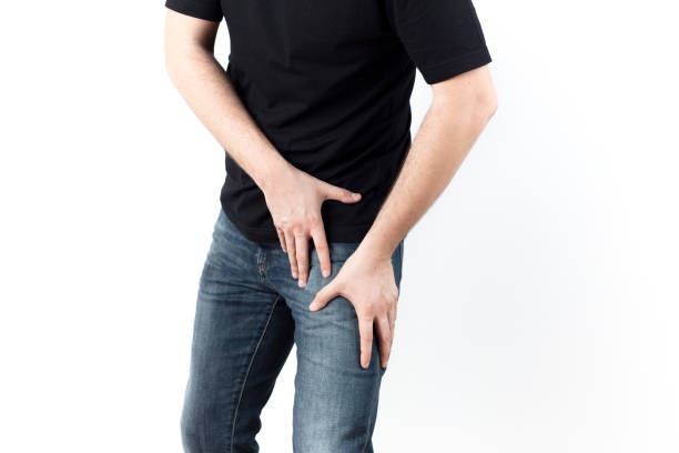 young man with leg and groin pain stock photo