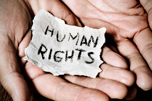 young man  with the text human rights stock photo