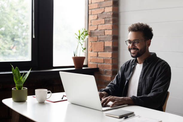 Young man working from home. Creative professional have meeting online Businessman using laptop computer in office. Student studying online. Entrepreneur, creative occupation, work from home, freelance, online learning, studying concept. Distance education distance learning stock pictures, royalty-free photos & images