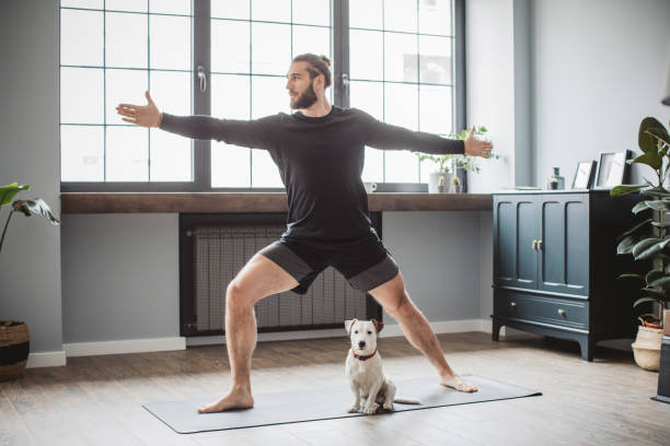 Young men at home practicing yoga stock photo