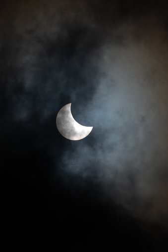 Young moon with dark cloud