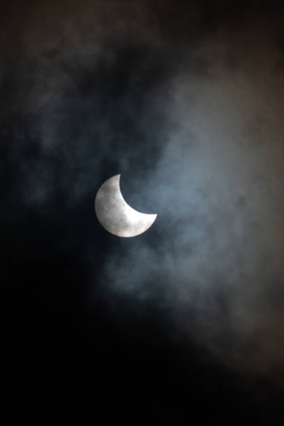Young moon with dark cloud stock photo