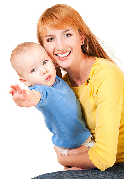 Young mother and son reaching out stock photo