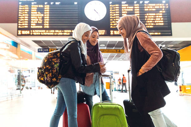 Young muslim women at train station leaving for a journey stock photo