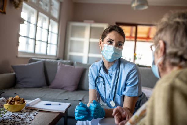Young nurse is helping senior woman. stock photo