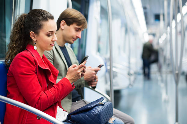 jeunes passagers en voiture de métro - smartphone car photos et images de collection