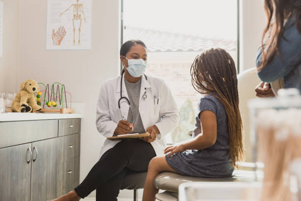 Young patient talks with pediatrician stock photo