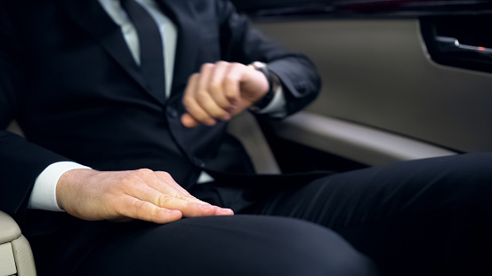Young Politician Late For Meeting Looking At Watch Stuck In