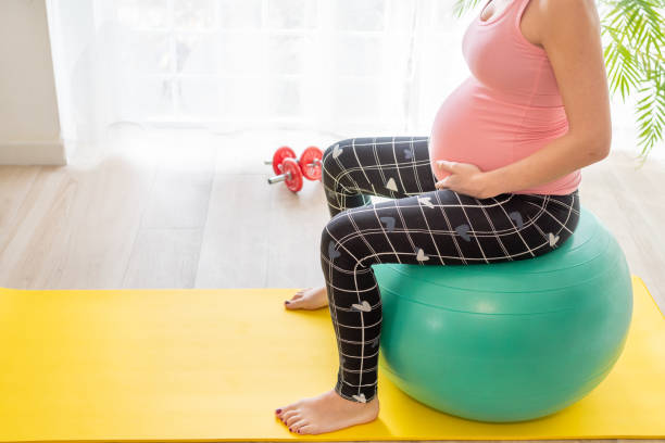 young pregnant woman sitting on a fitness ball does exercises to strengthen the pelvic floor in pregnancy during childbirth preparation classes young pregnant woman sitting on a fitness ball does exercises to strengthen the pelvic floor in pregnancy during childbirth preparation classes pelvic floor stock pictures, royalty-free photos & images