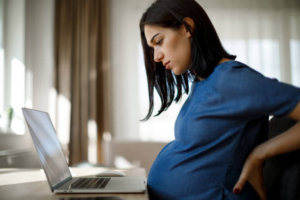 Young pregnant woman suffering from backache Young pregnant woman suffering from backache difficulties in pregnancy stock pictures, royalty-free photos & images