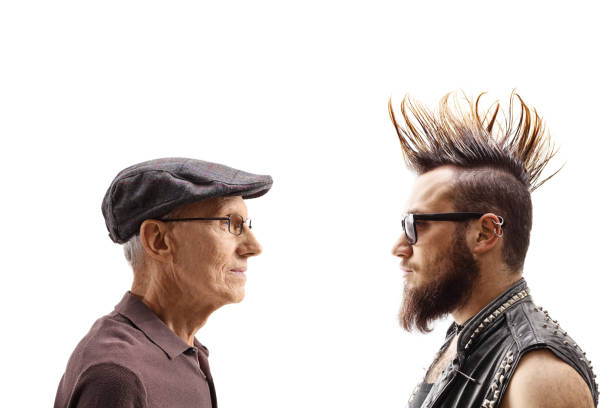 Young punk and a senior man looking at each other Young punk and a senior man looking at each other isolated on white background contrasts stock pictures, royalty-free photos & images