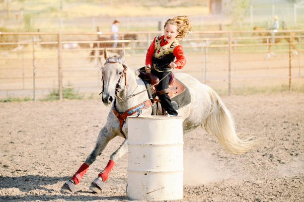 Young Rodeo Princess Barrel Racing For the First Time. stock photo