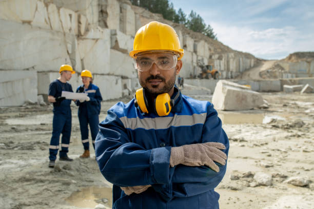 Young serious builder in workwear stock photo