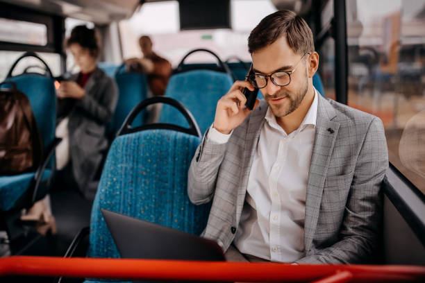 Young smiling businessman on city bus stock photo