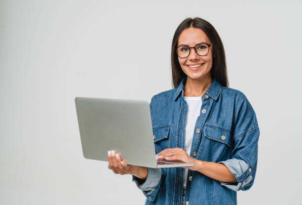 Young smiling caucasian student freelancer woman using laptop for remote work, e-learning at university college, e-banking, online shopping, webinars isolated in white background stock photo