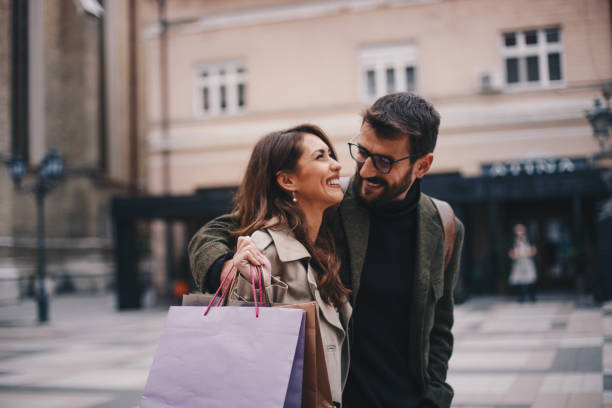 Young smiling couple enjoys in promenade. stock photo
