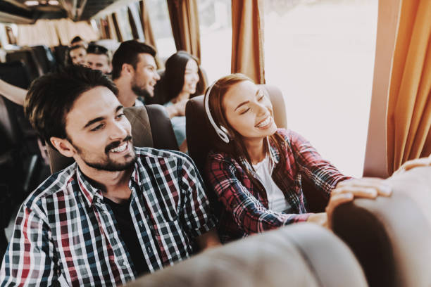 Young Smiling Couple Traveling on Tourist Bus stock photo