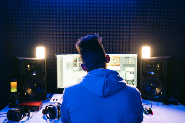 Young sound producer working at studio stock photo