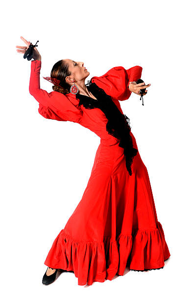 young Spanish woman dancing flamenco with castanets in her hands stock photo