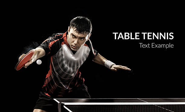 Young sports man tennis-player in play on black background Portrait Of Young Man Playing Tennis On Black Background table tennis stock pictures, royalty-free photos & images