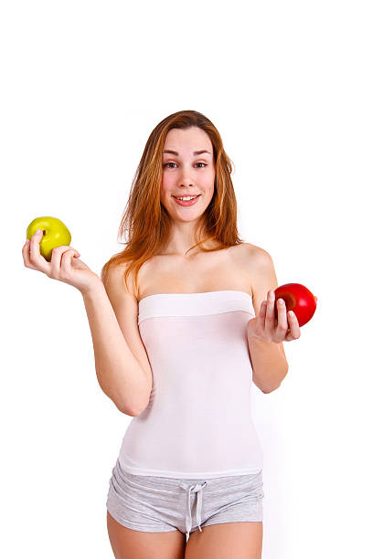 Young, sporty, fit and beautiful girl with apples isolated stock photo