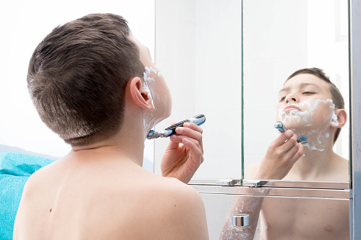 Young Teenage Boy Shaving For The First Time Stock Photo hq picture Young Teenage Boy Shaving For The First Time Stock Photo
