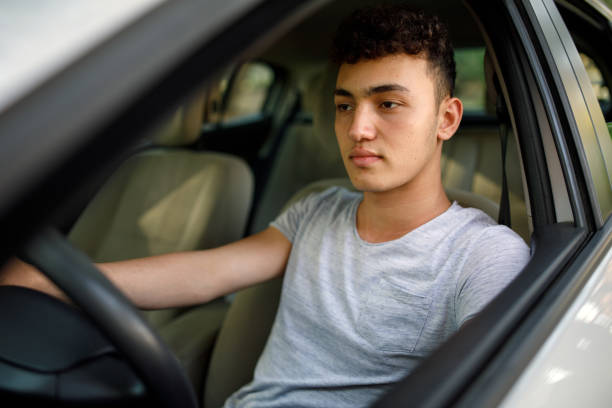 Young teenager learns how to drive the car stock photo