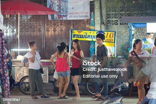 Young thai people at street market stall for sweet iced drinks