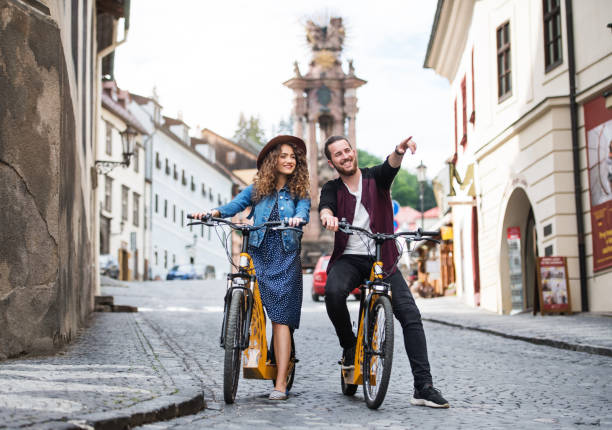 Young tourist couple travellers with electric scooters in small town. Young tourist couple travellers with electric scooters in small town, sightseeing. slovakia stock pictures, royalty-free photos & images