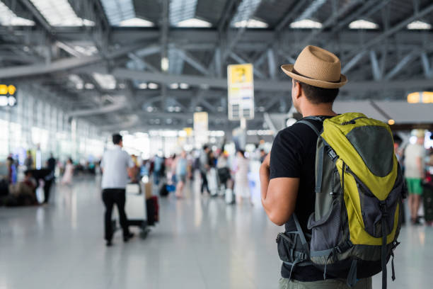 Young traveler man in the airport stock photo