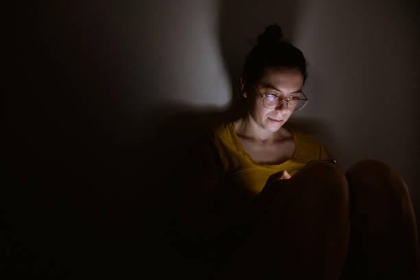 Young woman addicted to technology Young woman addicted to technology. Fear of missing out concept - FOMO. fomo stock pictures, royalty-free photos & images