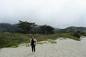 istock A young woman admiring the beautiful views off endless beach and ocean along the california coast, on a misty morning in Stinson Beach, Northern California, United States 1403675058