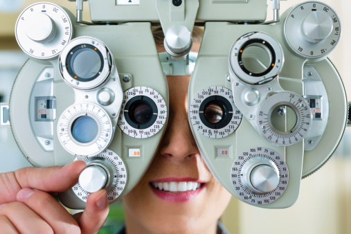 Young Woman At Phoropter For Eye Test Stock Photo ...