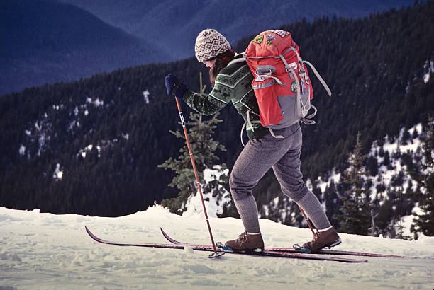 Skiing at Hurricane Ridge Olympic National Park, Washington, USA - December 30, 1982: A young woman carrying a red pack is cross country skiing on a snow covered meadow at Hurricane Ridge. jeff goulden olympic national park stock pictures, royalty-free photos & images