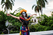 istock Young woman celebrating the day of the dead outdoors 1411248874