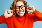 istock Young woman clenching fists in excitement 1299925188