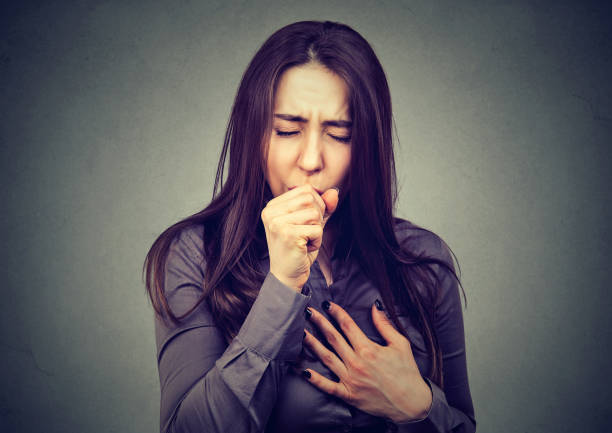Young woman coughing stock photo