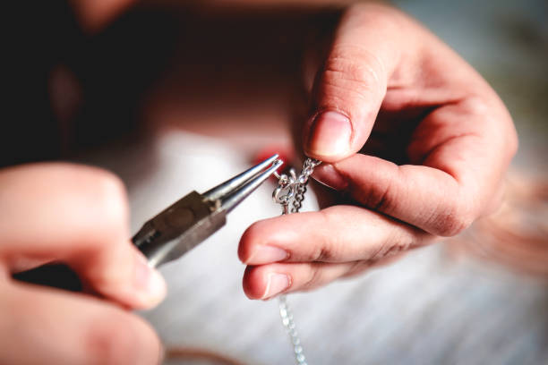 Young woman crafting jewelry stock photo