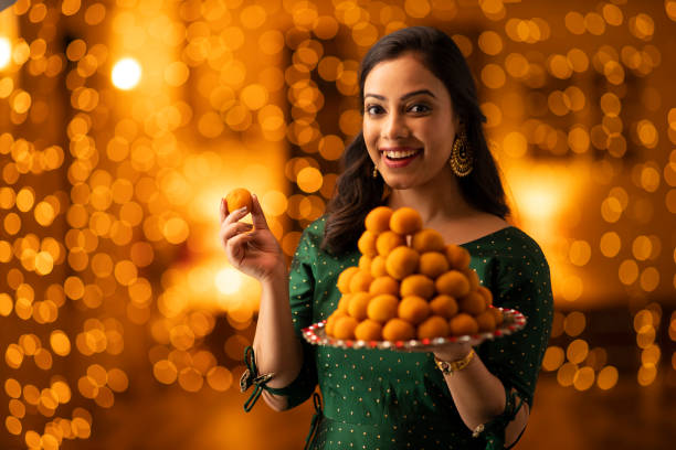 young woman diwali celebrate - stock photo Indian, Indian culture, festival, ethnicity, woman, adult, Diwali, mithai stock pictures, royalty-free photos & images