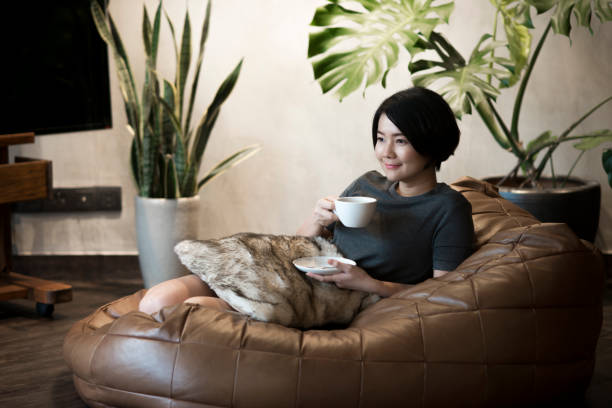 Young woman drinking coffee at home. stock photo
